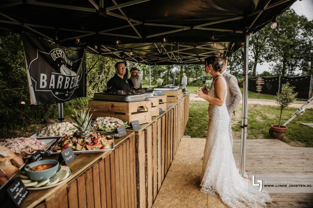 Bruidspaar bij het barbecuebuffet
